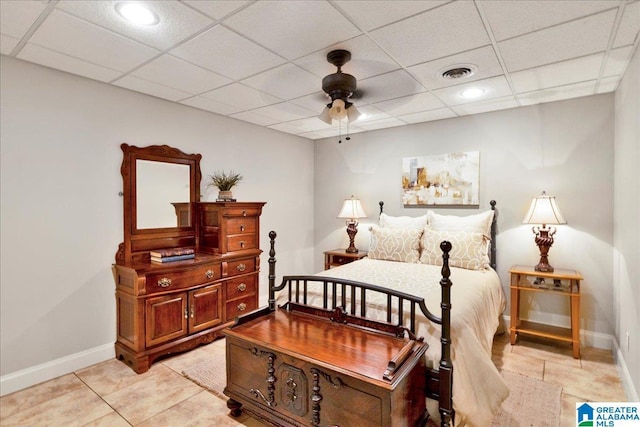 bedroom with light tile patterned floors, a paneled ceiling, and ceiling fan