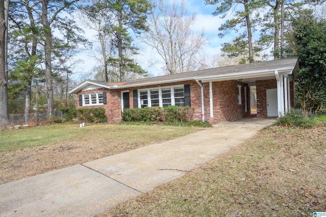 ranch-style home featuring a front yard and a carport