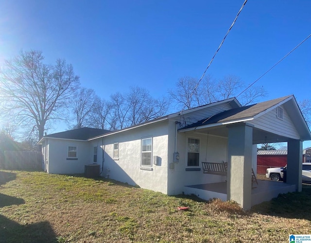 view of property exterior with a yard and central AC unit