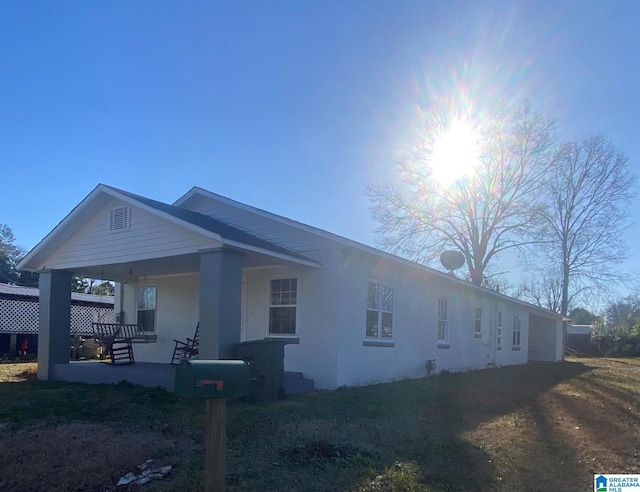 view of property exterior featuring covered porch