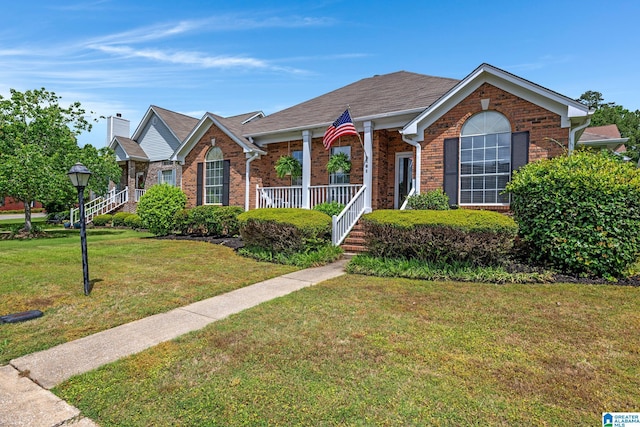 view of front of property featuring covered porch and a front yard