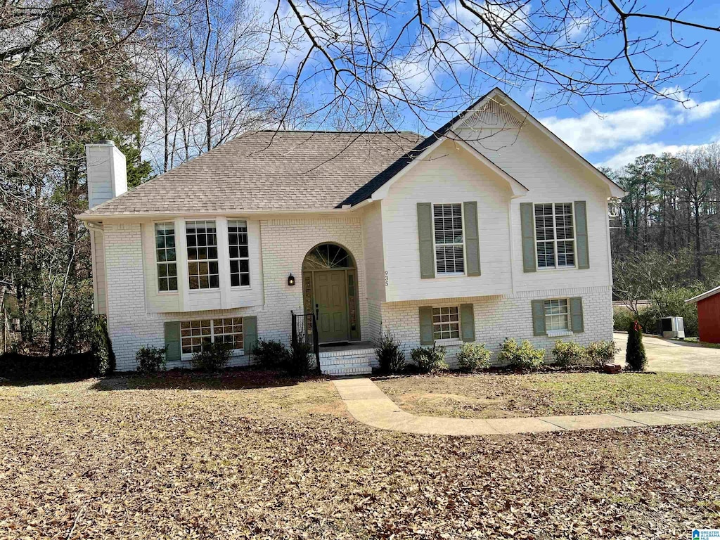 split foyer home featuring central AC unit