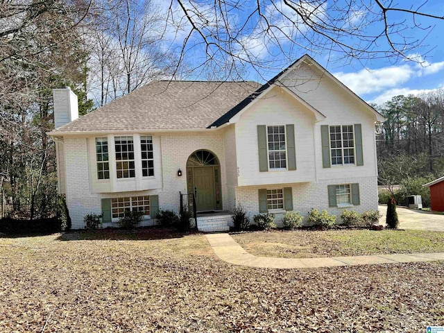 split foyer home featuring central AC unit