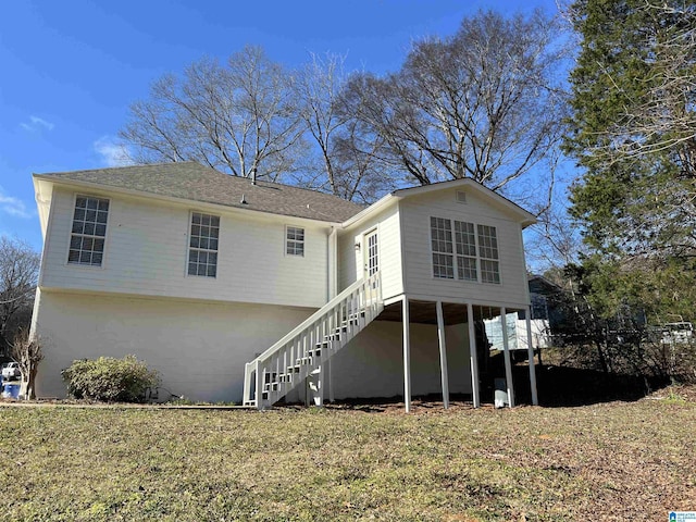 back of property featuring a yard