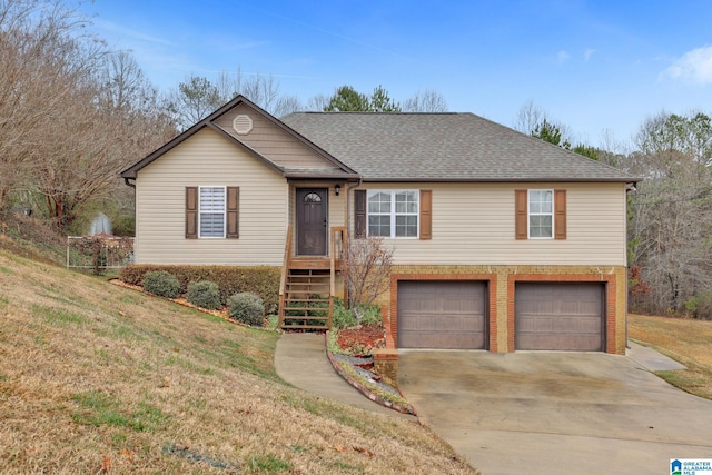 view of front of house with a front yard and a garage