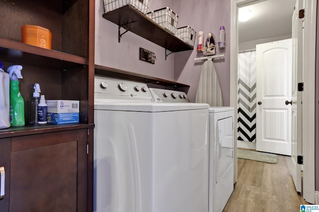 clothes washing area with light wood-type flooring and independent washer and dryer