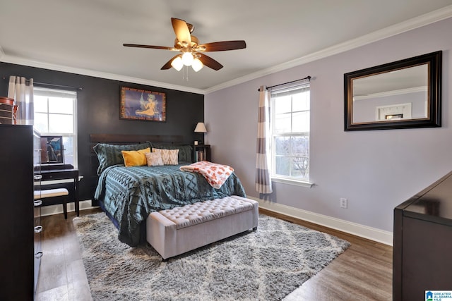 bedroom featuring ceiling fan, ornamental molding, dark wood-type flooring, and multiple windows