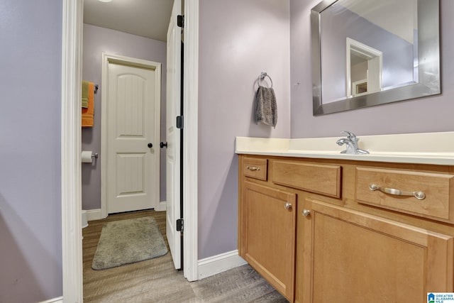 bathroom with vanity and hardwood / wood-style flooring