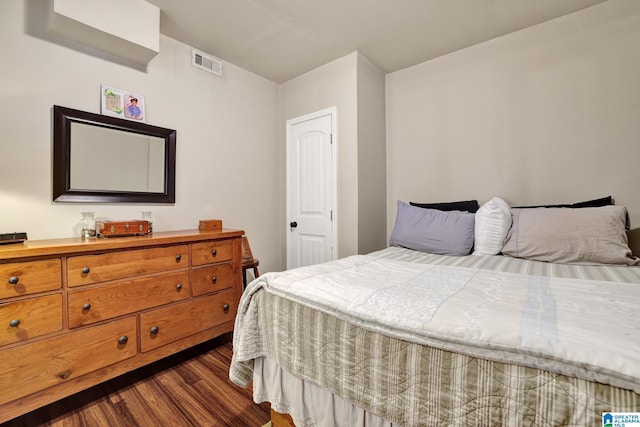 bedroom with dark hardwood / wood-style floors