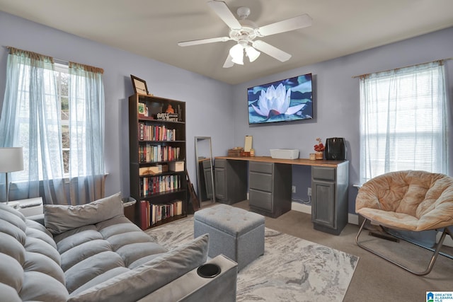 office with ceiling fan, a healthy amount of sunlight, and light colored carpet