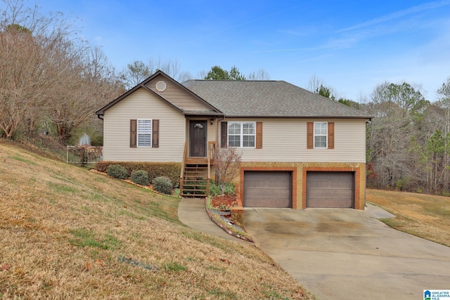 ranch-style home with a garage and a front lawn