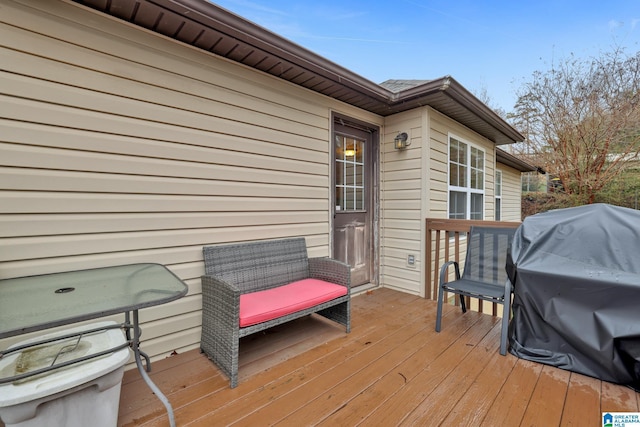 wooden deck with a grill