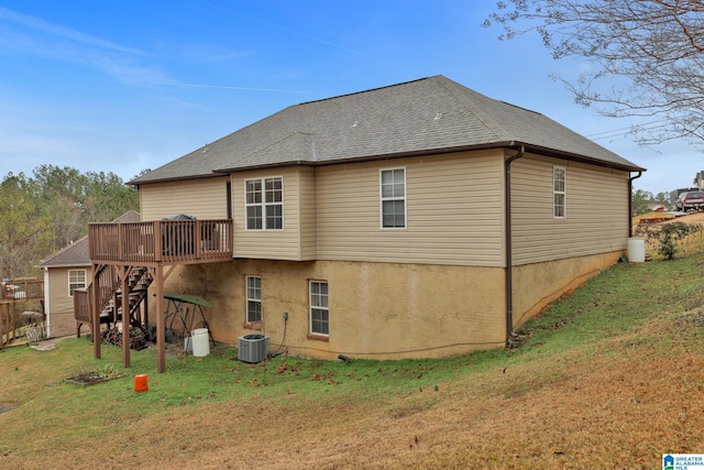 back of property with central AC, a lawn, and a wooden deck