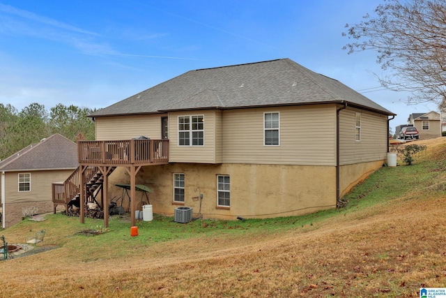 rear view of house featuring a lawn, a deck, and central air condition unit