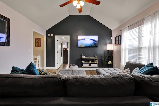 living room with ceiling fan, lofted ceiling, and hardwood / wood-style flooring