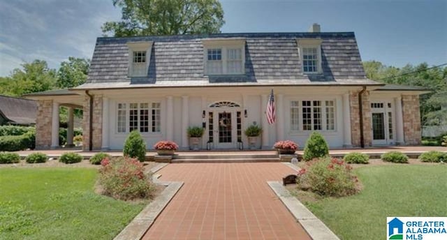 rear view of house featuring a lawn