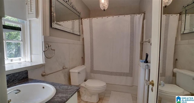 bathroom featuring tile patterned flooring, vanity, and toilet