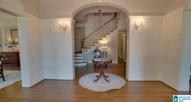 entryway featuring hardwood / wood-style floors and a chandelier