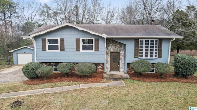 bi-level home with an outbuilding, a front lawn, and a garage