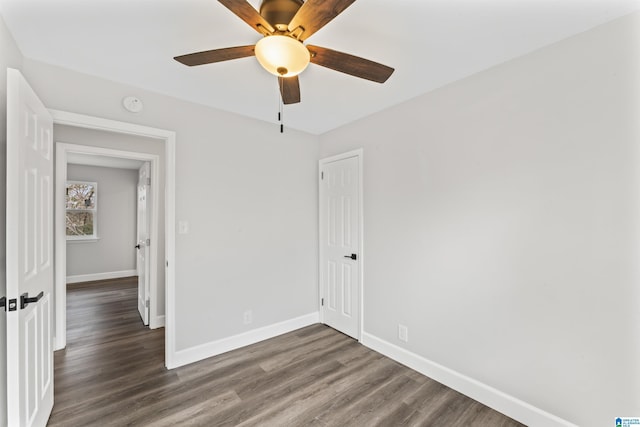 unfurnished room featuring dark hardwood / wood-style flooring and ceiling fan