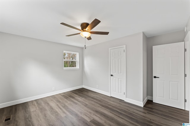 unfurnished bedroom featuring ceiling fan and dark wood-type flooring