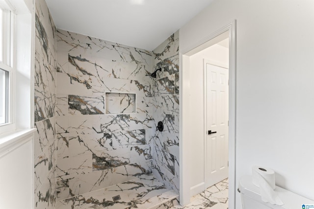 bathroom featuring toilet and tiled shower