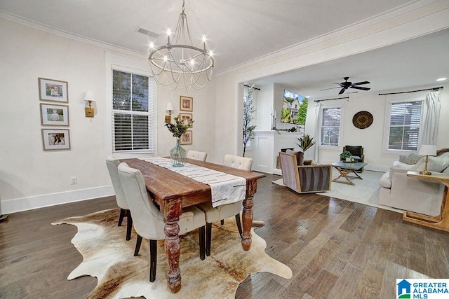 dining room featuring ceiling fan with notable chandelier, dark hardwood / wood-style flooring, and ornamental molding