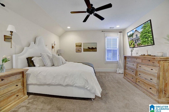 bedroom with ceiling fan, lofted ceiling, and light carpet