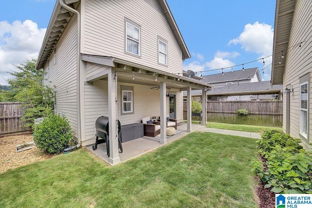 back of house with a patio area, a yard, and an outdoor hangout area