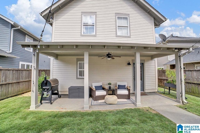 back of house with a lawn, a patio area, and ceiling fan