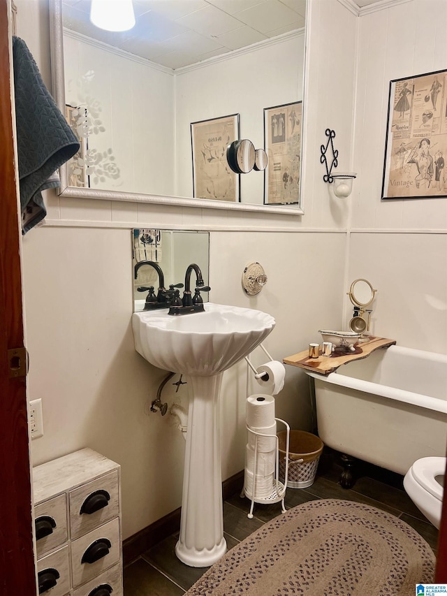 bathroom with a tub to relax in, tile patterned floors, tasteful backsplash, and ornamental molding