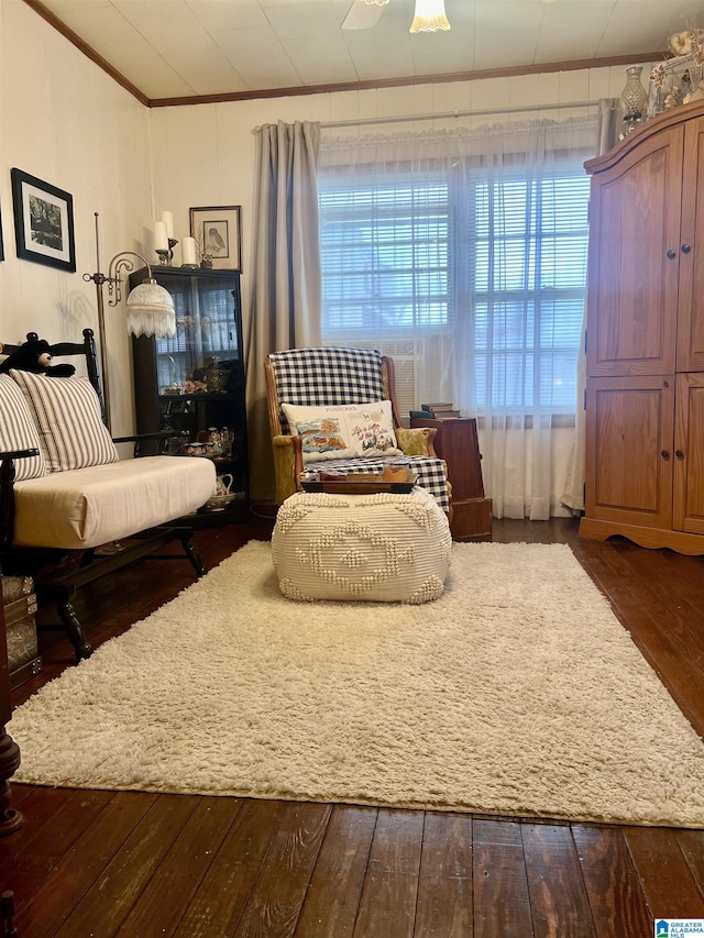 sitting room featuring dark hardwood / wood-style flooring, a wealth of natural light, and crown molding