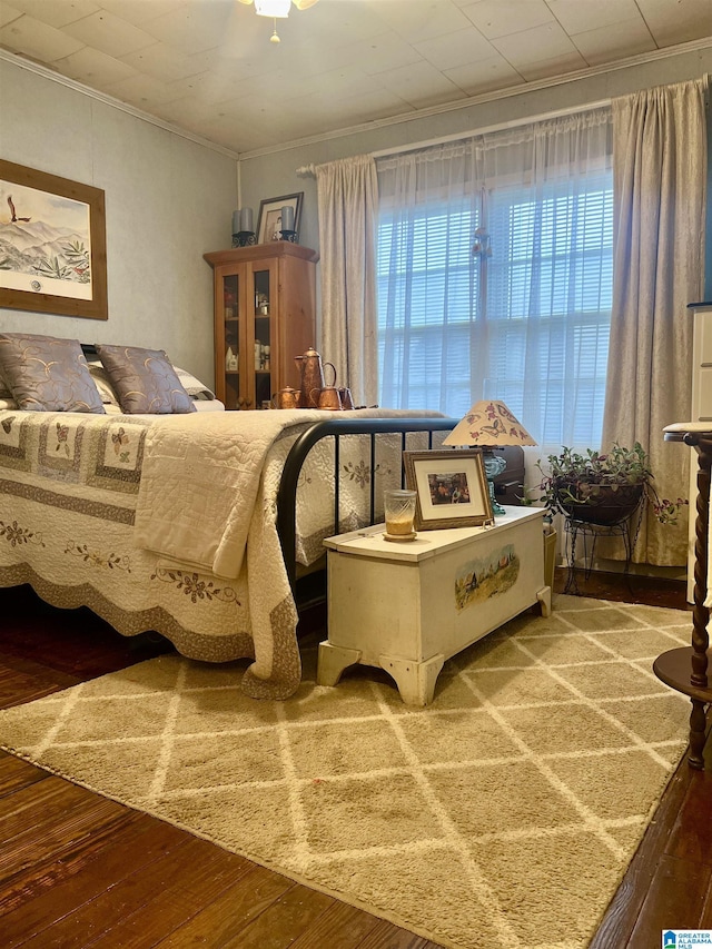 bedroom featuring crown molding and wood-type flooring