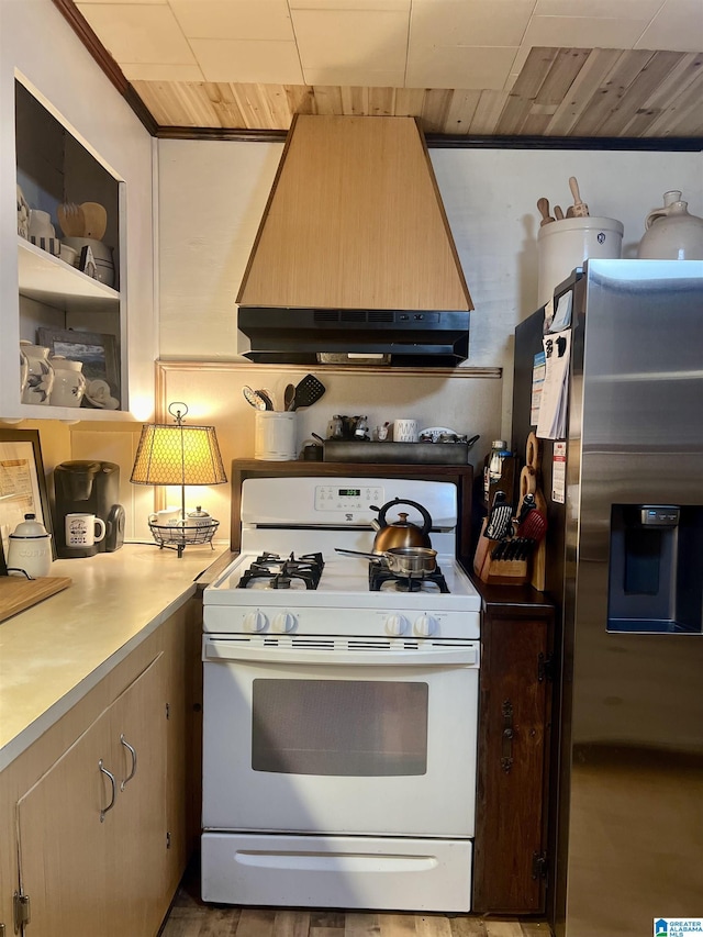 kitchen featuring gas range gas stove, stainless steel fridge with ice dispenser, ventilation hood, wood ceiling, and custom exhaust hood