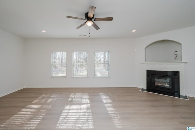 unfurnished living room with ceiling fan and light wood-type flooring