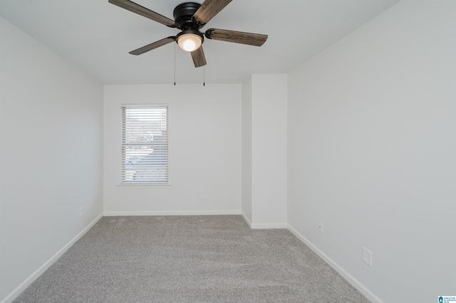 empty room featuring ceiling fan and light colored carpet