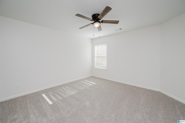 carpeted empty room featuring ceiling fan