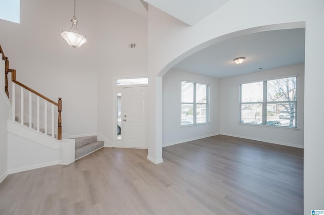 entryway featuring light hardwood / wood-style flooring and a high ceiling