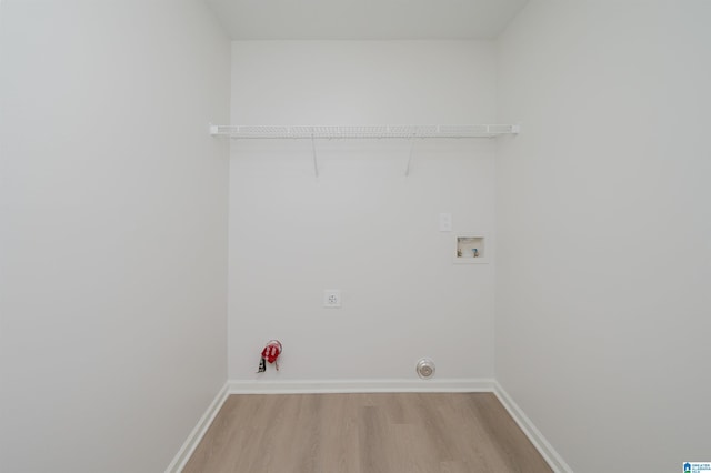 laundry area with hookup for a gas dryer, hookup for a washing machine, light hardwood / wood-style flooring, and hookup for an electric dryer