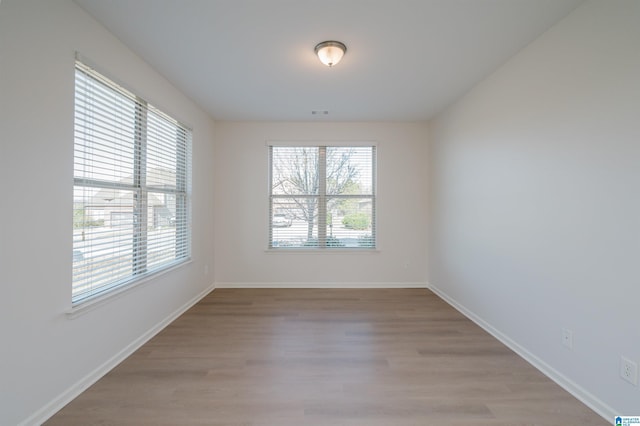 unfurnished room with light hardwood / wood-style flooring