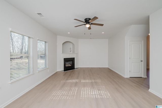 unfurnished living room with ceiling fan and light hardwood / wood-style flooring