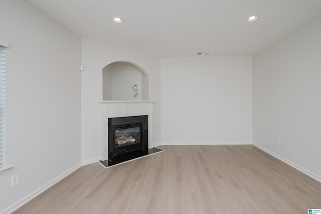 unfurnished living room with light hardwood / wood-style flooring