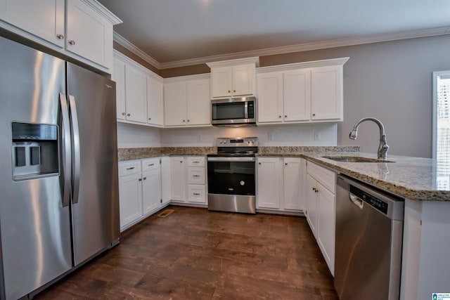 kitchen with sink, light stone countertops, appliances with stainless steel finishes, white cabinetry, and kitchen peninsula