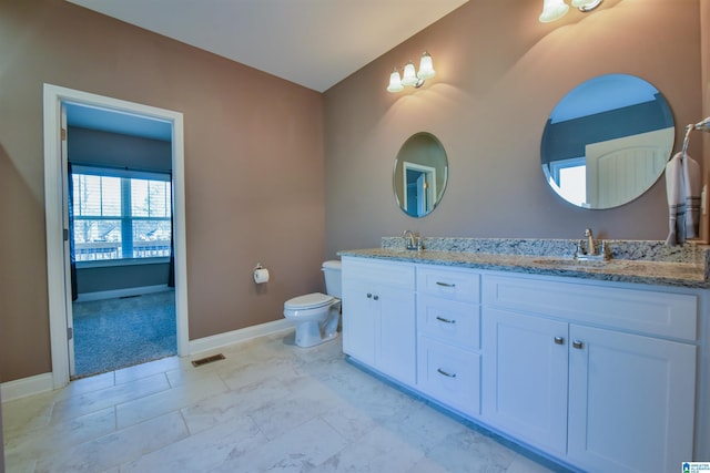 bathroom featuring vanity and toilet