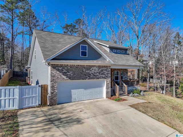 view of front facade with a porch, a garage, and a front lawn