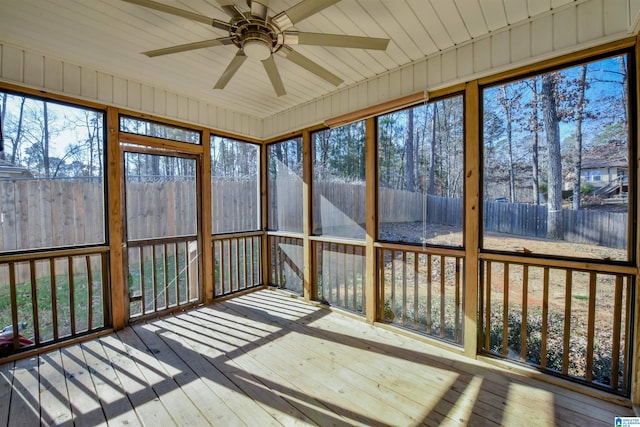 unfurnished sunroom featuring ceiling fan