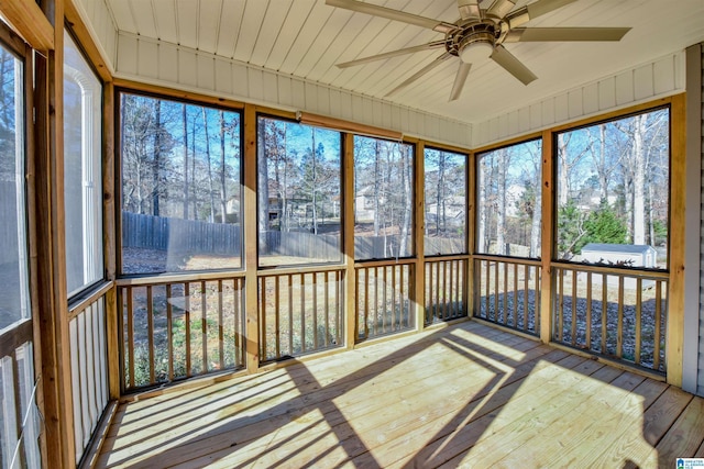 unfurnished sunroom featuring ceiling fan