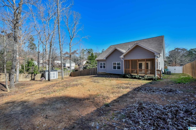 back of house with a storage shed and central air condition unit