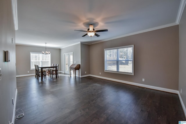 spare room with ceiling fan with notable chandelier, dark hardwood / wood-style floors, and crown molding