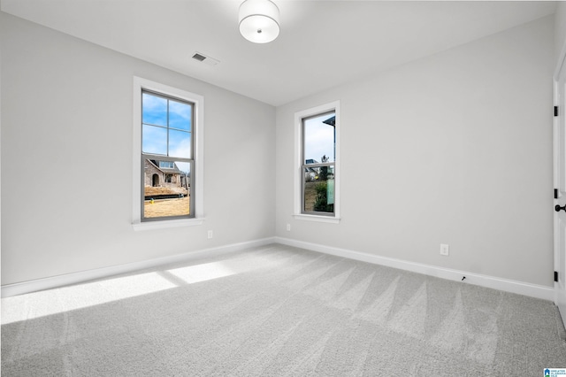 unfurnished room with plenty of natural light and carpet